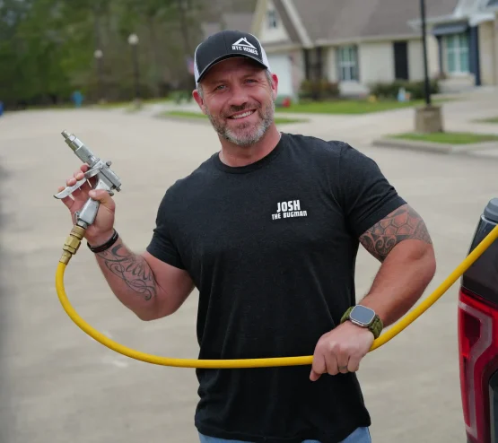 Professional pest control technician holding treatment equipment in Southeast Texas