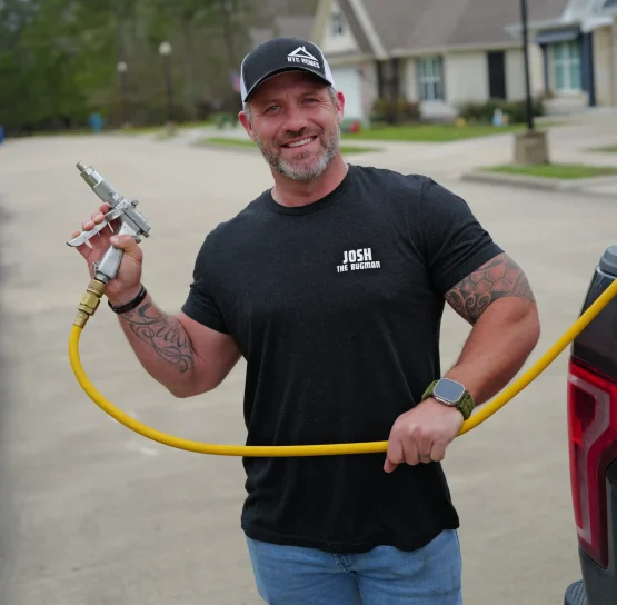 Professional pest control technician holding treatment equipment in Southeast Texas